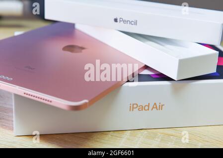 Bangkok, Thailand - August 21, 2021: New Apple iPad rose gold color, rear view logo Apple launch Tablet iPad Air 2020-2021 (4th Gen.) with box and app Stock Photo