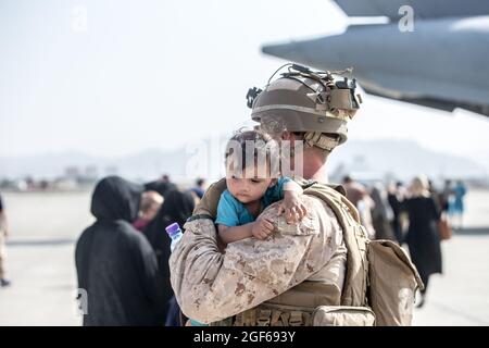 A Marine with Special Purpose Marine Air-Ground Task Force-Crisis Response-Central Command (SPMAGTF-CR-CC) calms an infant during an evacuation at Hamid Karzai International Airport, Kabul, Afghanistan, August 21, 2021. US service members are assisting the Department of State with an orderly drawdown of designated personnel in Afghanistan. Photo by Samuel Ruiz/US Marine Corps via CNP/ABACAPRESS.COM Stock Photo