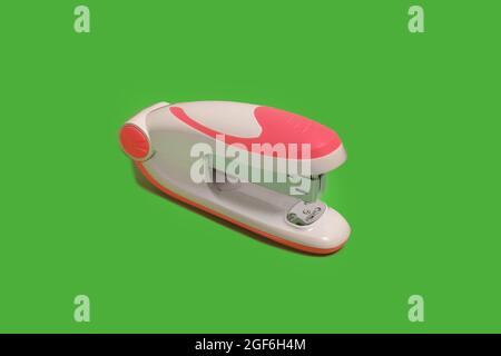 stapler on a green background. school and office accessories Stock Photo