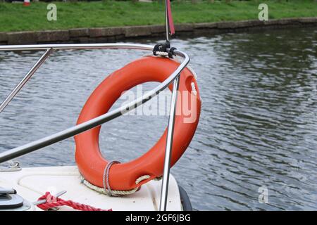 close up of Lifebuoy on bow of a small boat on waterway Stock Photo