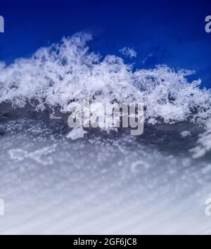 Snow on a large scale. Snowflakes on a blue background. Snow background. Stock Photo