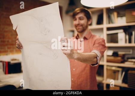 Architect hold in hands blueprint layout design project at office european bureau Stock Photo