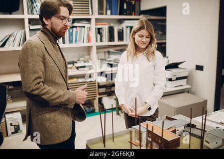 Architects discuss blueprints and layout design project at office bureau Stock Photo