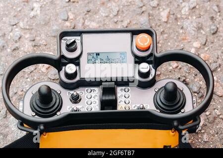 Remote control of a lifting car crane. Panel with joysticks and buttons for controlling the telescopic bucket of the crane Stock Photo