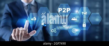 Businessman presses button p2p peer-to-peer on virtual interface. Stock Photo