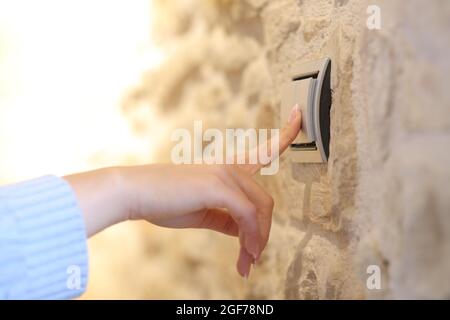 Close up of a woman hand turning on the light at home Stock Photo