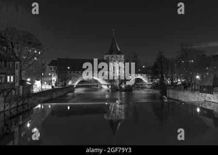 Historic chain footbridge and front vestibule with the Schlayer tower, Pegnitz with barrage in front, twilight, Nuremberg, Middle Franconia, Bavaria Stock Photo