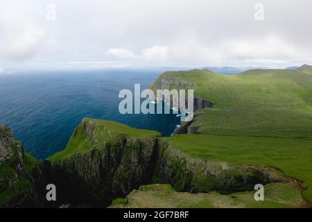 Aerial view, Asmundarstakkur cliff, Sandvik, Suduroy, Faroe Islands ...