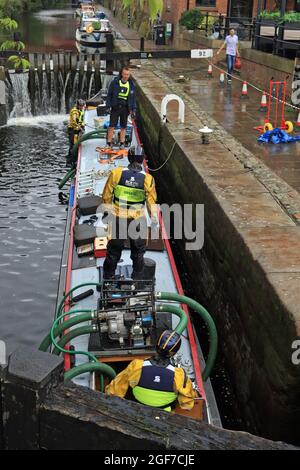 Nearly all the water has being pumped from a sunken canal boat on the Rochdale canal and its floating again. This is image 5 of the rescue operation Stock Photo