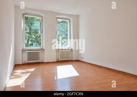 Empty white room in an old building with old radiators Stock Photo