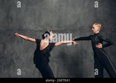 Young two dancers man and woman pair dancing in ballroom dance cha-cha-cha Stock Photo