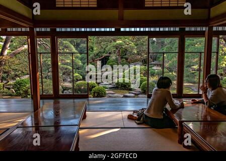 Two ladies in Shibamata tea house and traditional garden, Tokyo, Japan. Stock Photo