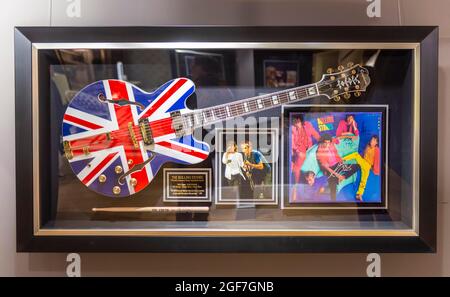 Electric guitar with Great Britain flag of the Rolling Stones, siginated album of the Rolling Stones in a display window, luxury department stores Stock Photo