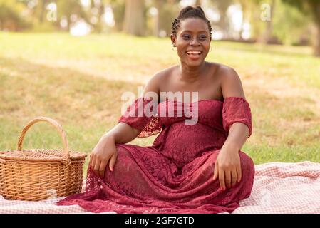 Cheerful pregnant black female during picnic Stock Photo