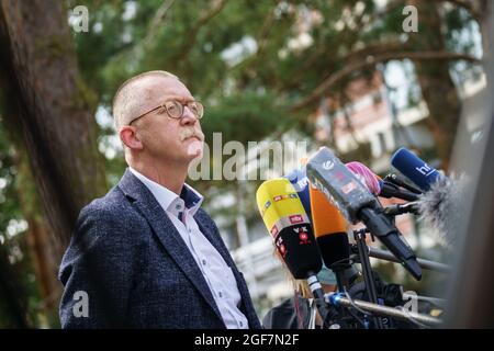 Darmstadt, Germany. 24th Aug, 2021. Manfred Efinger, Chancellor of the Technische Hochschule (TU) Darmststadt, speaks to media representatives in front of building L201 on the Lichtwiese campus of the TU Darmstadt. The day before, six people had been brought to clinics here with symptoms of poisoning such as malaise and discoloration, and a 30-year-old student was in critical condition. Credit: Frank Rumpenhorst/dpa/Alamy Live News Stock Photo