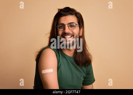 Closeup of happy arab guy got vaccinated against coronavirus Stock Photo