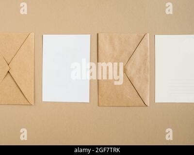Two blank postcards and envelopes on beige background. Top view Stock Photo