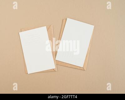 Two blank postcards and envelopes on beige background. Top view Stock Photo