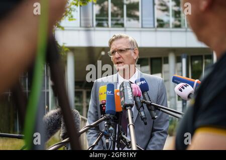 Darmstadt, Germany. 24th Aug, 2021. Chief Public Prosecutor Robert Hartmann speaks to media representatives in front of building L201 on the Lichtwiese campus of the TU Darmstadt. The day before, six people had been brought to clinics here with symptoms of poisoning such as malaise and discoloration, a 30-year-old student was in critical condition. Credit: Frank Rumpenhorst/dpa/Alamy Live News Stock Photo