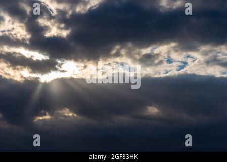 Rays of light shining throug dark clouds.Beautiful dramatic sky with sun rays.dramatic sky sun rays. Stock Photo