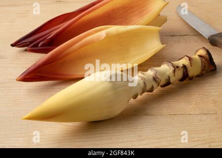 Fresh peeled raw tropical banana flower and leaves close up Stock Photo