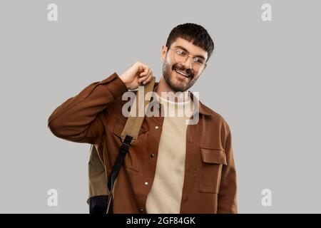 smiling young man in glasses with backpack Stock Photo