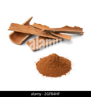 Dried Cinnamon bark and a heap of ground cinnamon powder isolated on white background Stock Photo