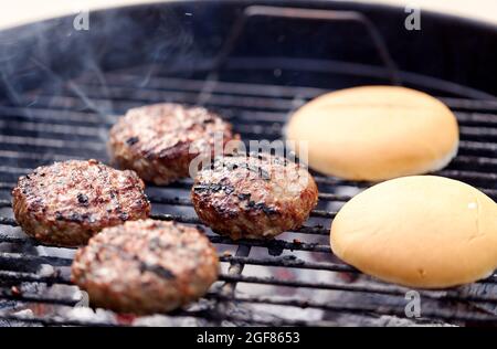 burger meat cutlets roasting on barbecue grill Stock Photo