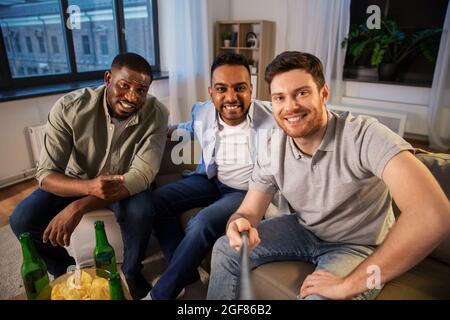 happy male friends taking selfie at home Stock Photo