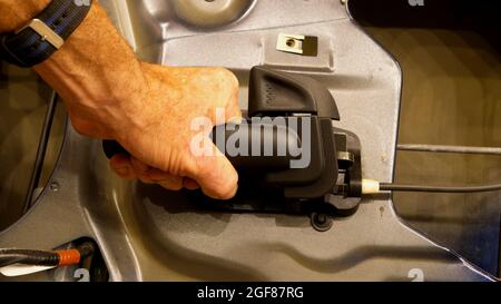 Interior Car Door Handle Being Gripped by a Hand Stock Photo