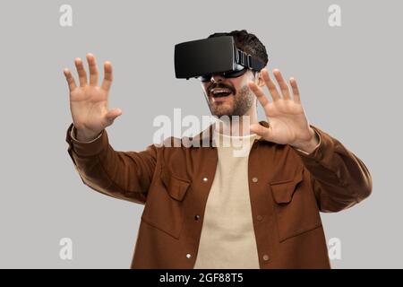 happy smiling young man in vr glasses Stock Photo
