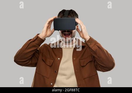 happy smiling young man in vr glasses Stock Photo