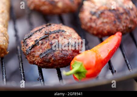burger meat cutlets and pepper roasting on grill Stock Photo