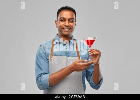 indian barman in apron with glass of cocktail Stock Photo