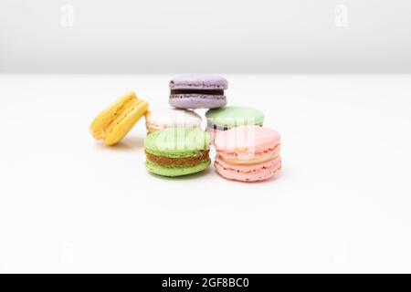 macaroons in different colours on a withe table Stock Photo