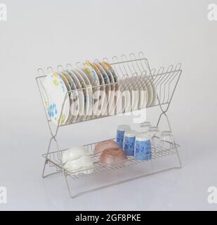 Stainless steel shelf for keeping dishes and cups on white background Stock Photo