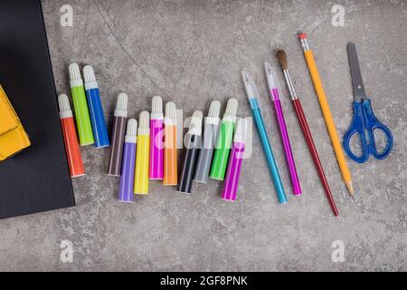 Items for the school on grey surface. Back to school. Stock Photo