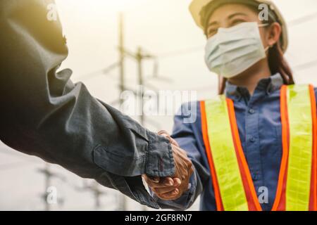 Closeup women engineer shake hand teamwork on site work success , Leadership Hand shake team Stock Photo