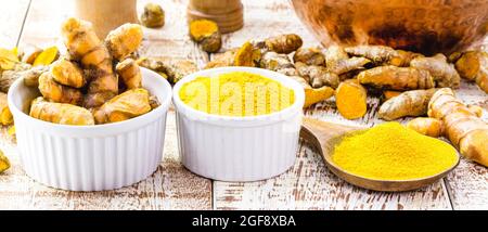 turmeric roots and turmeric powder, on a white table Stock Photo