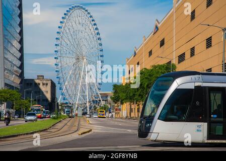 Rio de Janeiro, Brazil - January 7, 2021: VLT tram is passing in front of the Rio Star ferris wheel in the city center. Stock Photo
