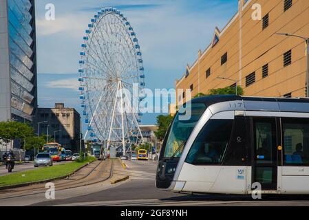 Rio de Janeiro, Brazil - January 7, 2021: VLT tram is passing in front of the Rio Star ferris wheel in the city center. Stock Photo