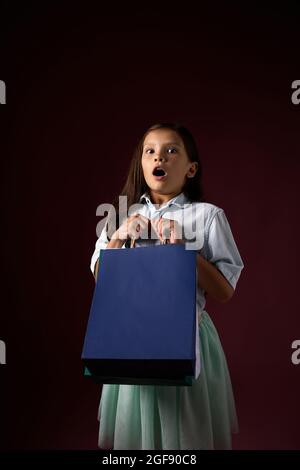 happy little child girl holds many shopping bags Stock Photo