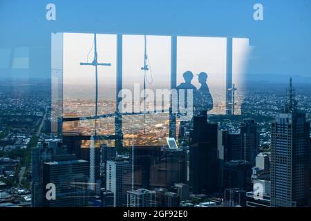 Silhouette of tourist looking at city from Eureka Tower, Melbourne, State Of Victoria, Australia