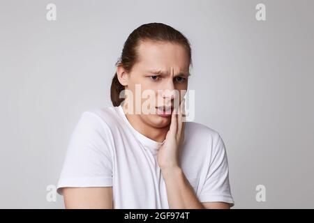 young unhappy man feeling pain suffering from bad tooth ache Stock Photo