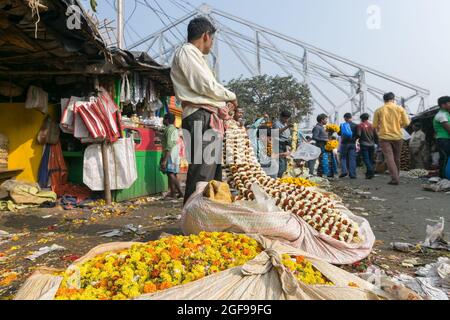 KOLKATA, WEST BENGAL / INDIA - FEBRUARY 13TH, 2016 : Buying and selling of flowers in crowded and colorful Mallik Ghat or Jagannath ghat flower market Stock Photo