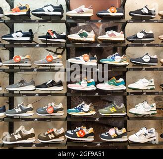 New Balance trainers, training shoes, footwear display in sports store. Stock Photo