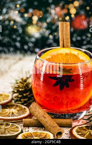 Christmas drink sangria or mulled wine, or bray, with apples, oranges, pomegranate and cinnamon sticks. Stock Photo