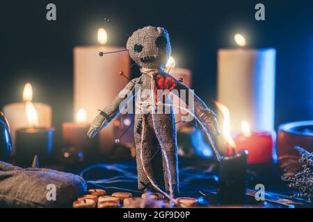 Voodoo Magic concept. Witchcraft with Voodoo doll. Close-up of rag puppet nipped with needles. Stock Photo