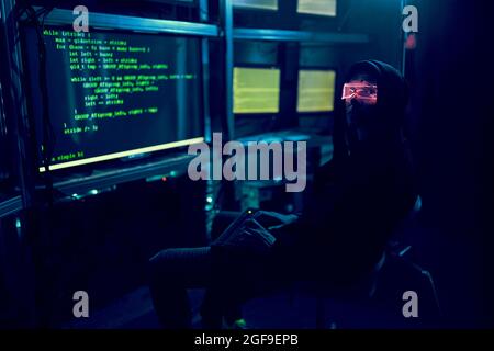 Cyber hacker breaks into databases to obtain information using a computer. Cybercrime and data security concept. Stock Photo