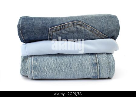 stack of blue jeans isolated on white background, space for text, close-up Stock Photo